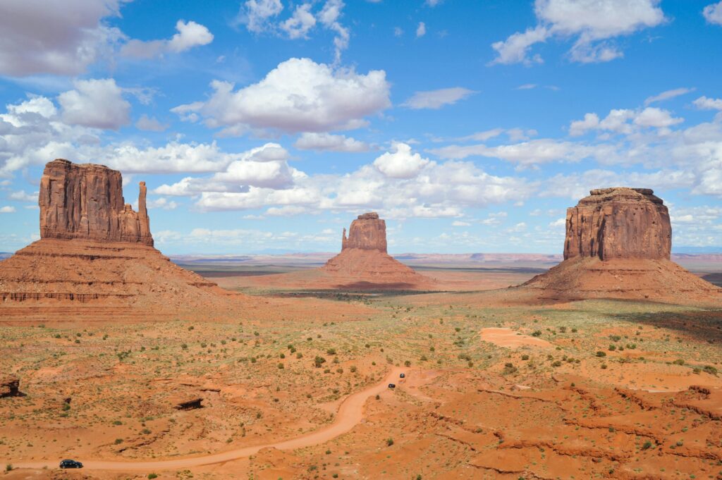 A breathtaking view of Monument Valley's buttes under a clear blue sky, perfect for travel enthusiasts.